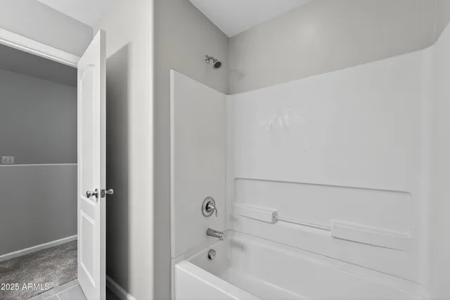 a bathroom with a granite countertop double vanity sink a mirror and lamp