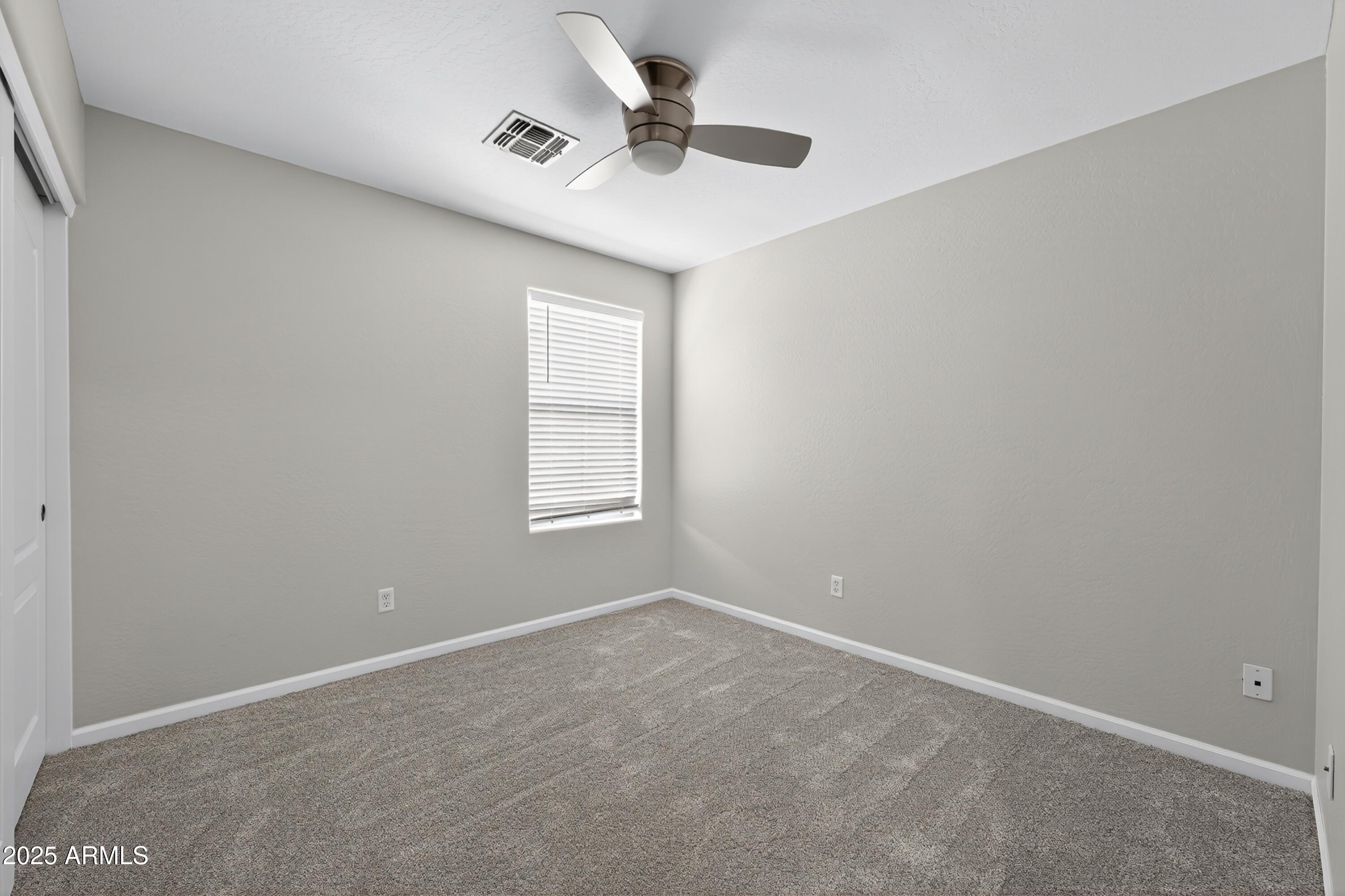 1250 South Rialto, Unit 31 Mesa, AZ 85209 - Photo 22 of 30 an empty room with a window and a ceiling fan