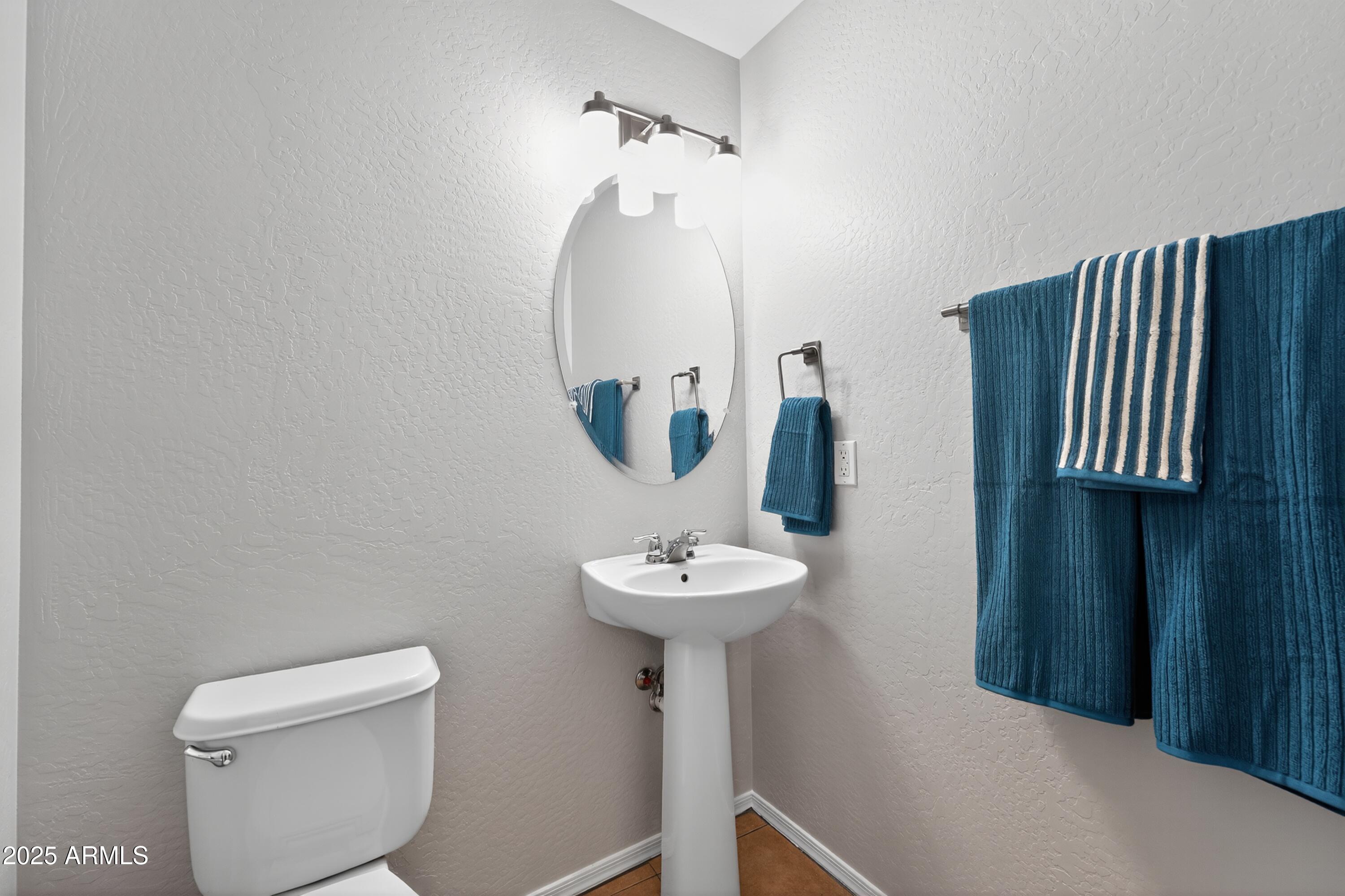 1250 South Rialto, Unit 31 Mesa, AZ 85209 - Photo 23 of 30 a bathroom with a sink a toilet and a mirror