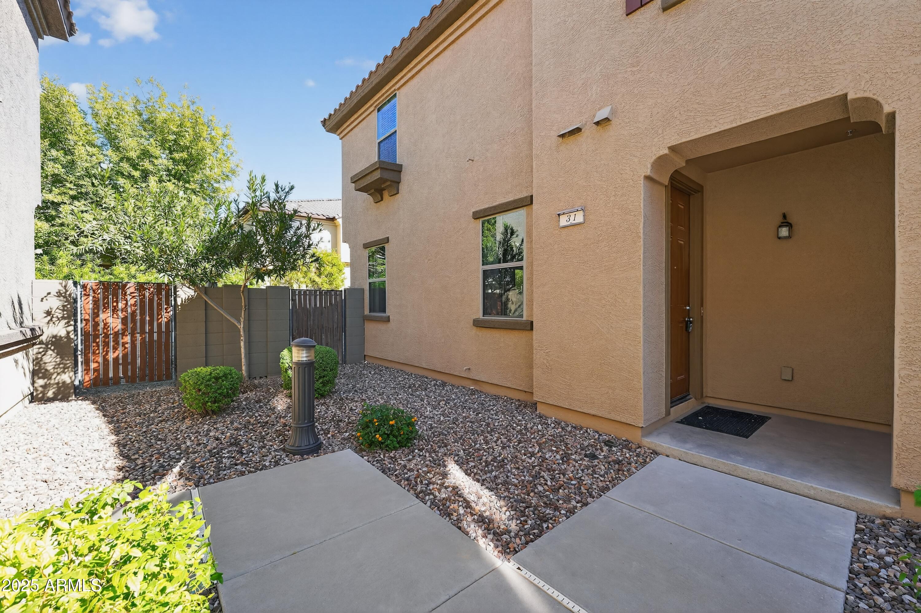 1250 South Rialto, Unit 31 Mesa, AZ 85209 - Photo 28 of 30 a front view of a house with garden