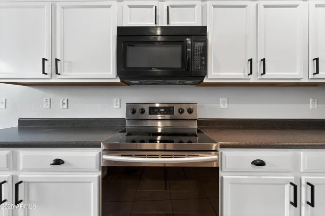 a stove top oven sitting inside of a kitchen