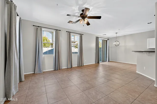 a view of an empty room with a ceiling fan
