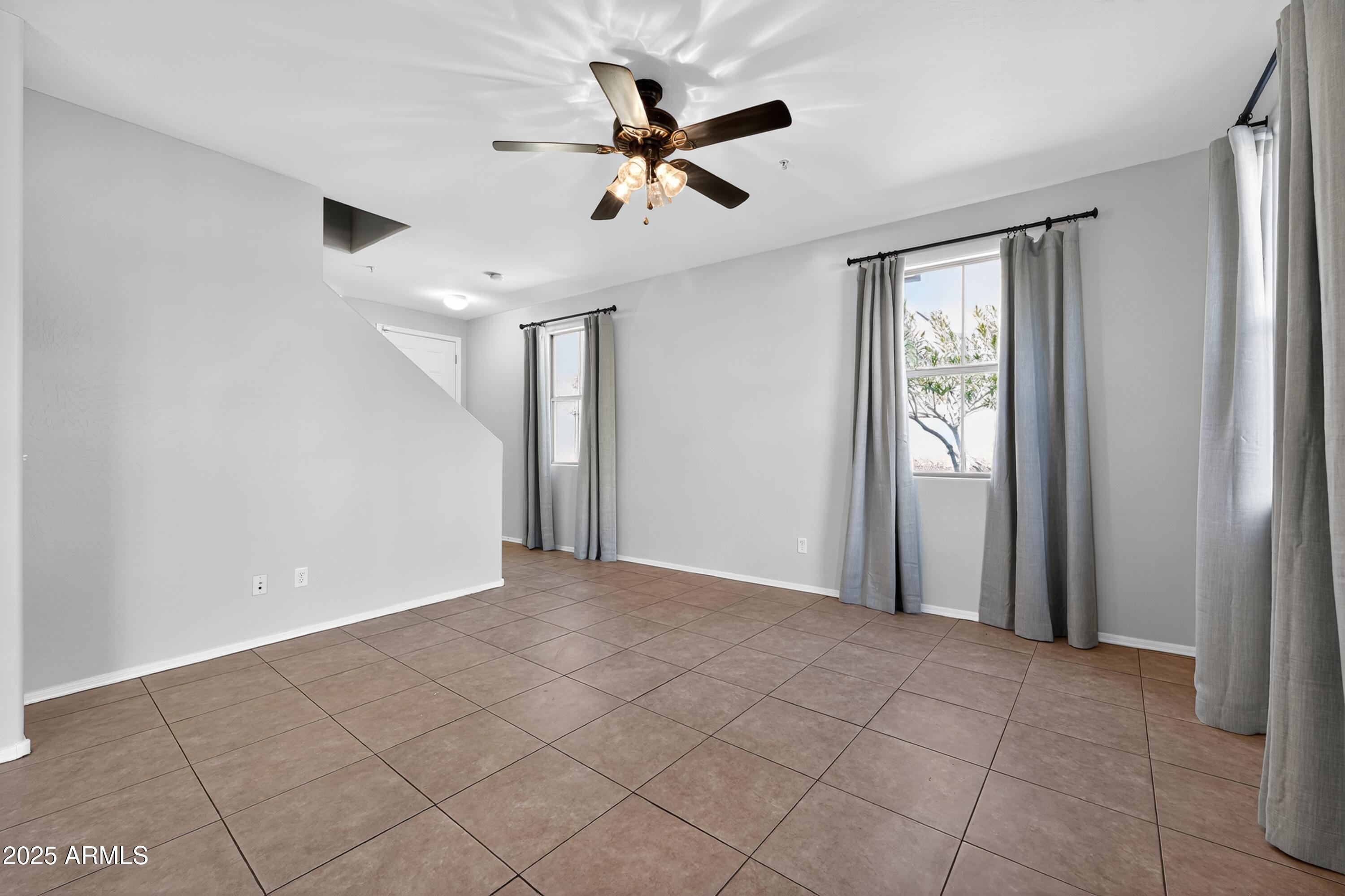 1250 South Rialto, Unit 31 Mesa, AZ 85209 - Photo 8 of 30 a view of an empty room with a ceiling fan