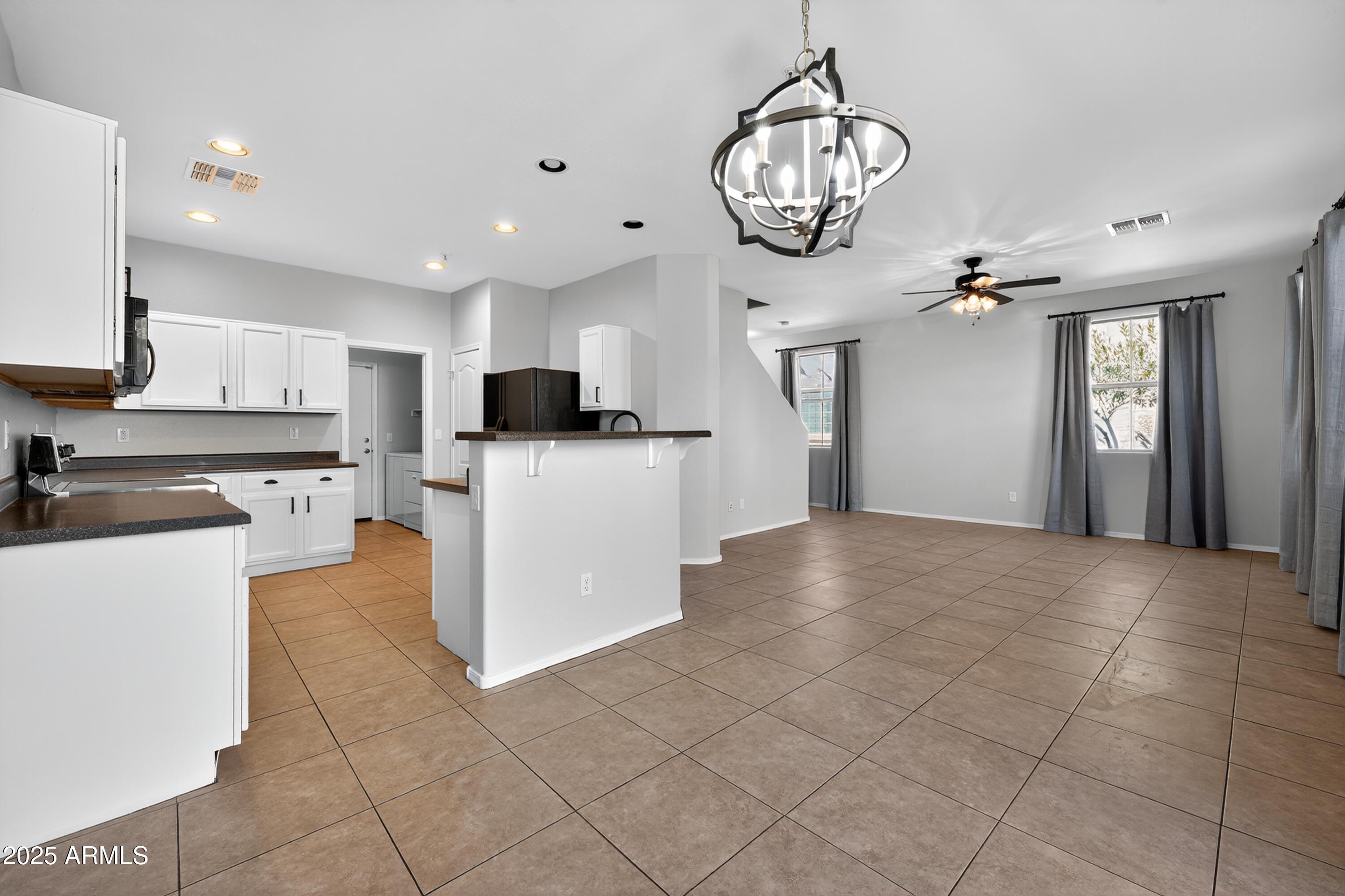 1250 South Rialto, Unit 31 Mesa, AZ 85209 - Photo 9 of 30 a view of a kitchen with microwave and cabinets