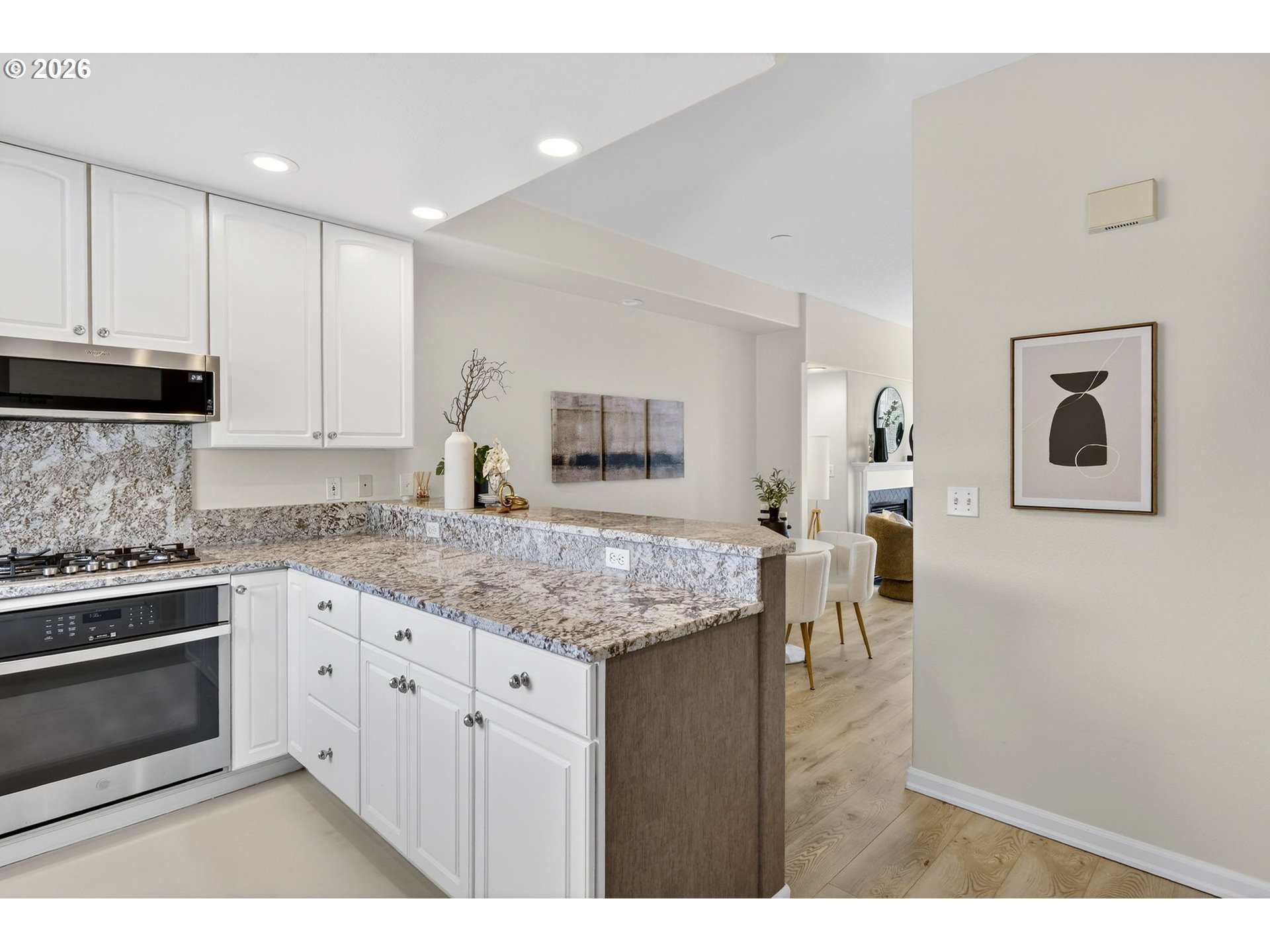 4934 Southwest 1st Avenue Portland, OR 97239 - Photo 14 of 33 a kitchen with stainless steel appliances granite countertop a stove a sink and a refrigerator