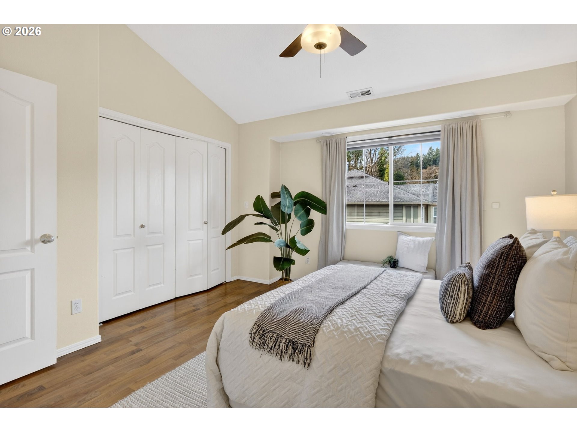 4934 Southwest 1st Avenue Portland, OR 97239 - Photo 17 of 33 a bedroom with a bed and a large window