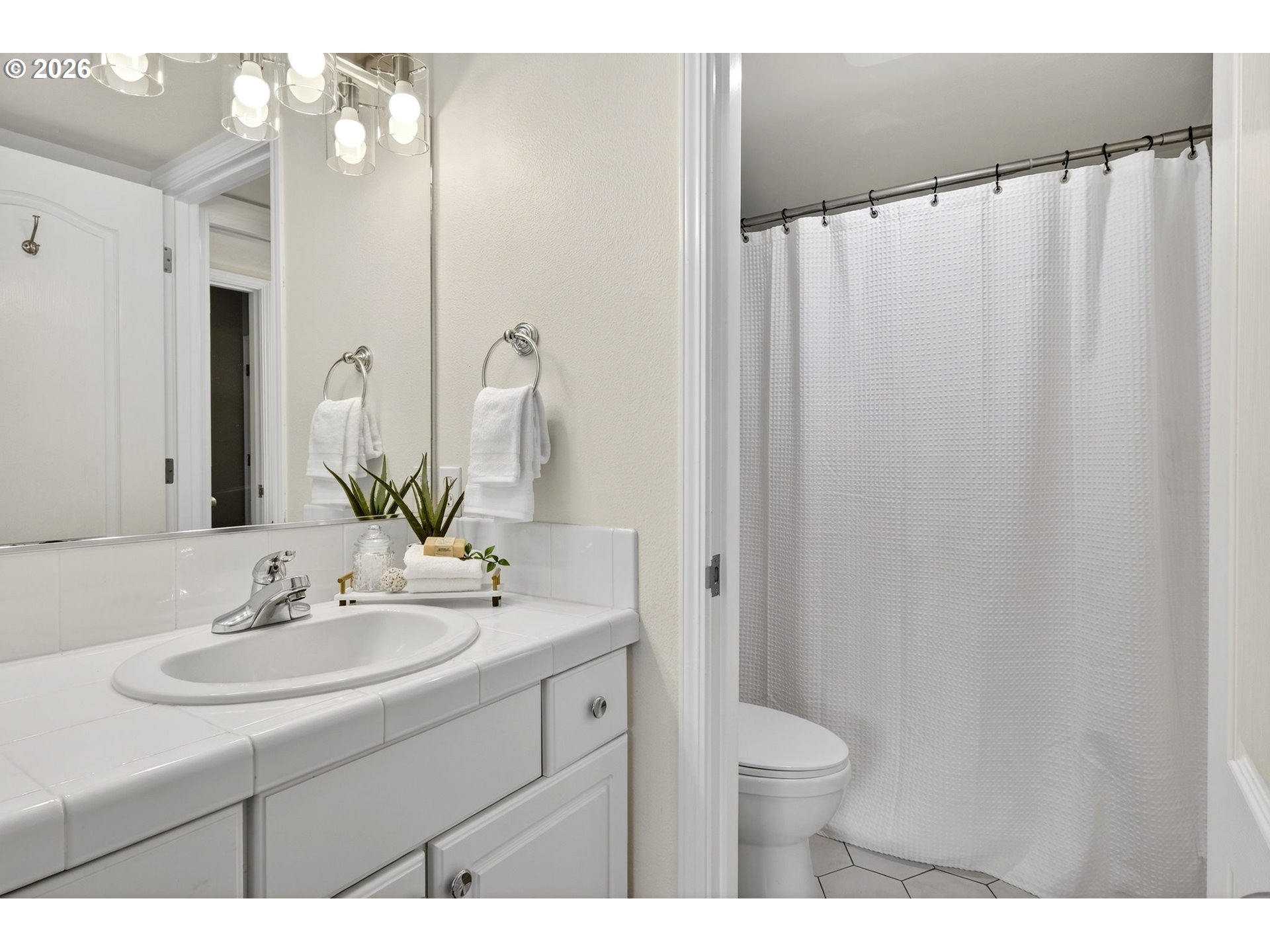 4934 Southwest 1st Avenue Portland, OR 97239 - Photo 20 of 33 a bathroom with a sink vanity mirror and toilet