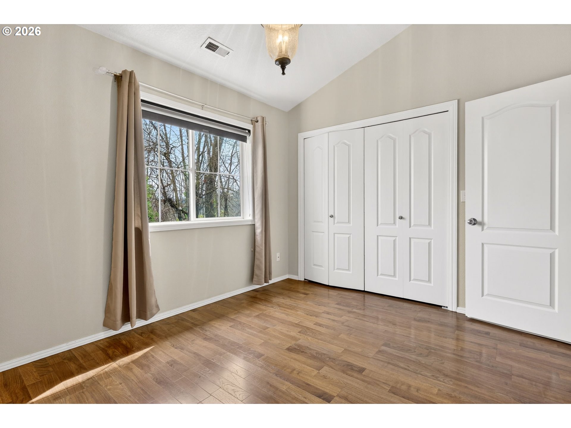 4934 Southwest 1st Avenue Portland, OR 97239 - Photo 22 of 33 a view of an empty room with wooden floor and a window