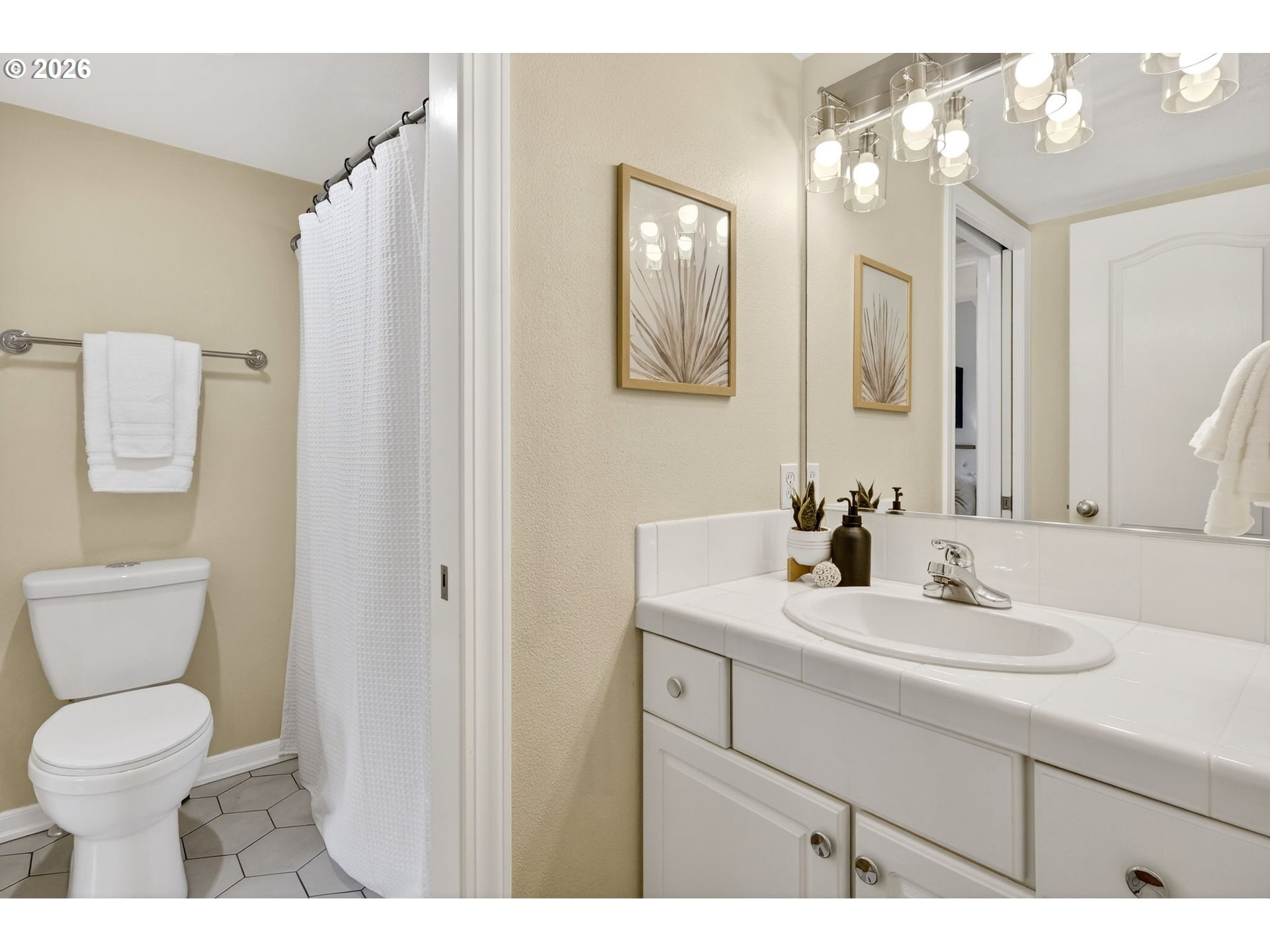 4934 Southwest 1st Avenue Portland, OR 97239 - Photo 24 of 33 a bathroom with a toilet sink and mirror
