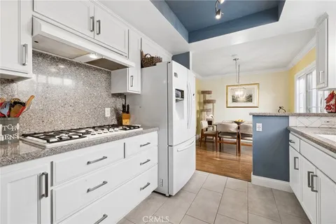 a kitchen with granite countertop cabinets and refrigerator