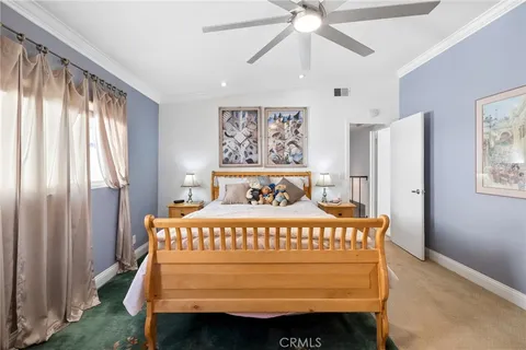 a bedroom with a bed a window and a chandelier