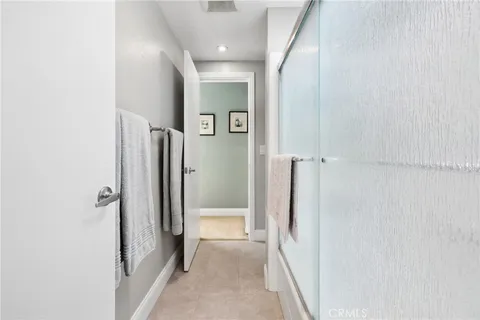 a view of a hallway with a glass door and door