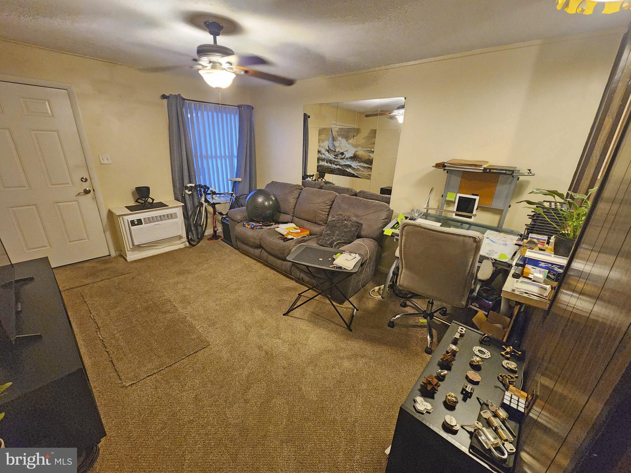 14001 Coastal Highway, Unit 322 Ocean City, MD 21842 - Photo 4 of 10 a living room with furniture