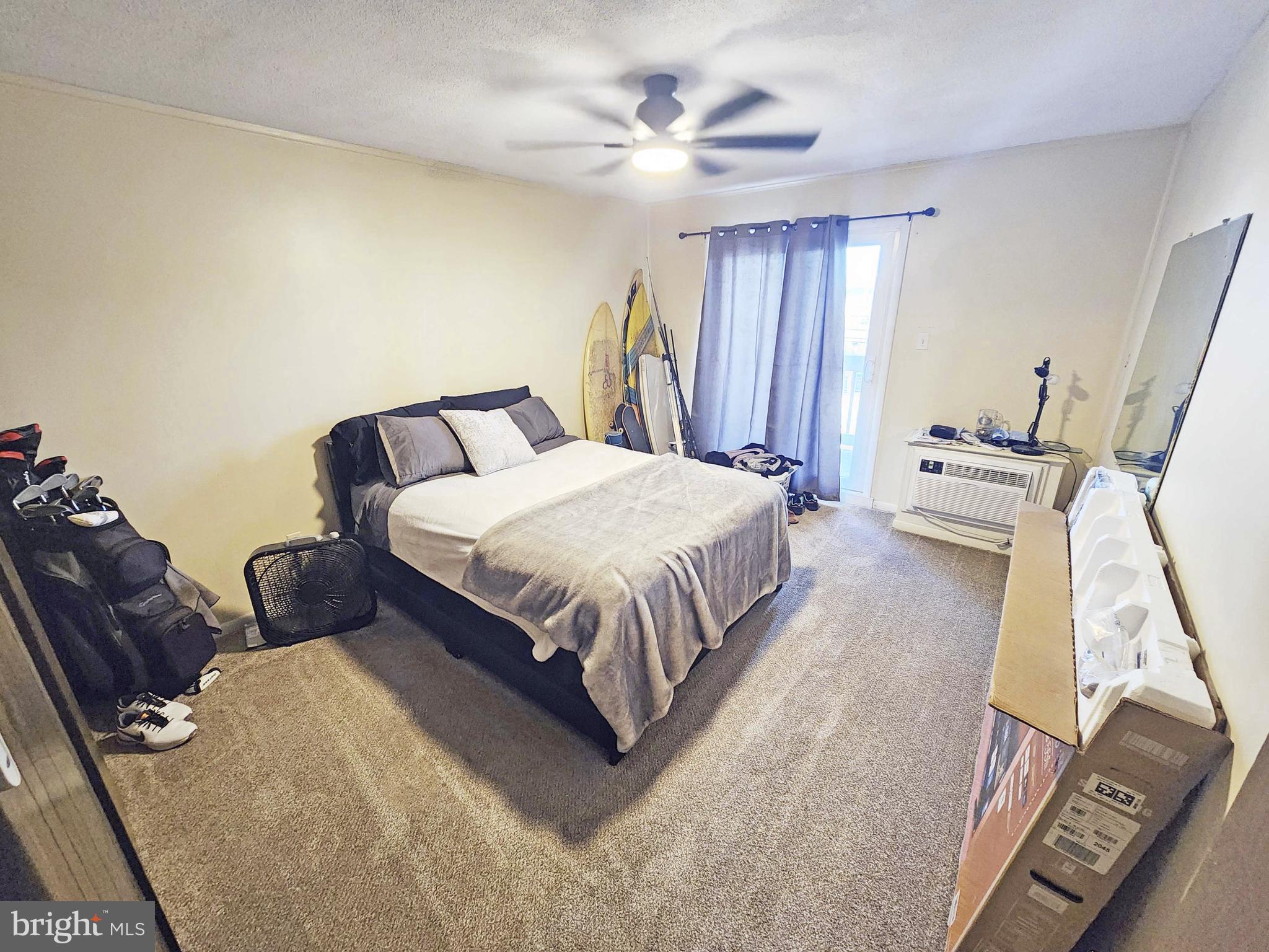 14001 Coastal Highway, Unit 322 Ocean City, MD 21842 - Photo 6 of 10 a bedroom with a bed and a chandelier