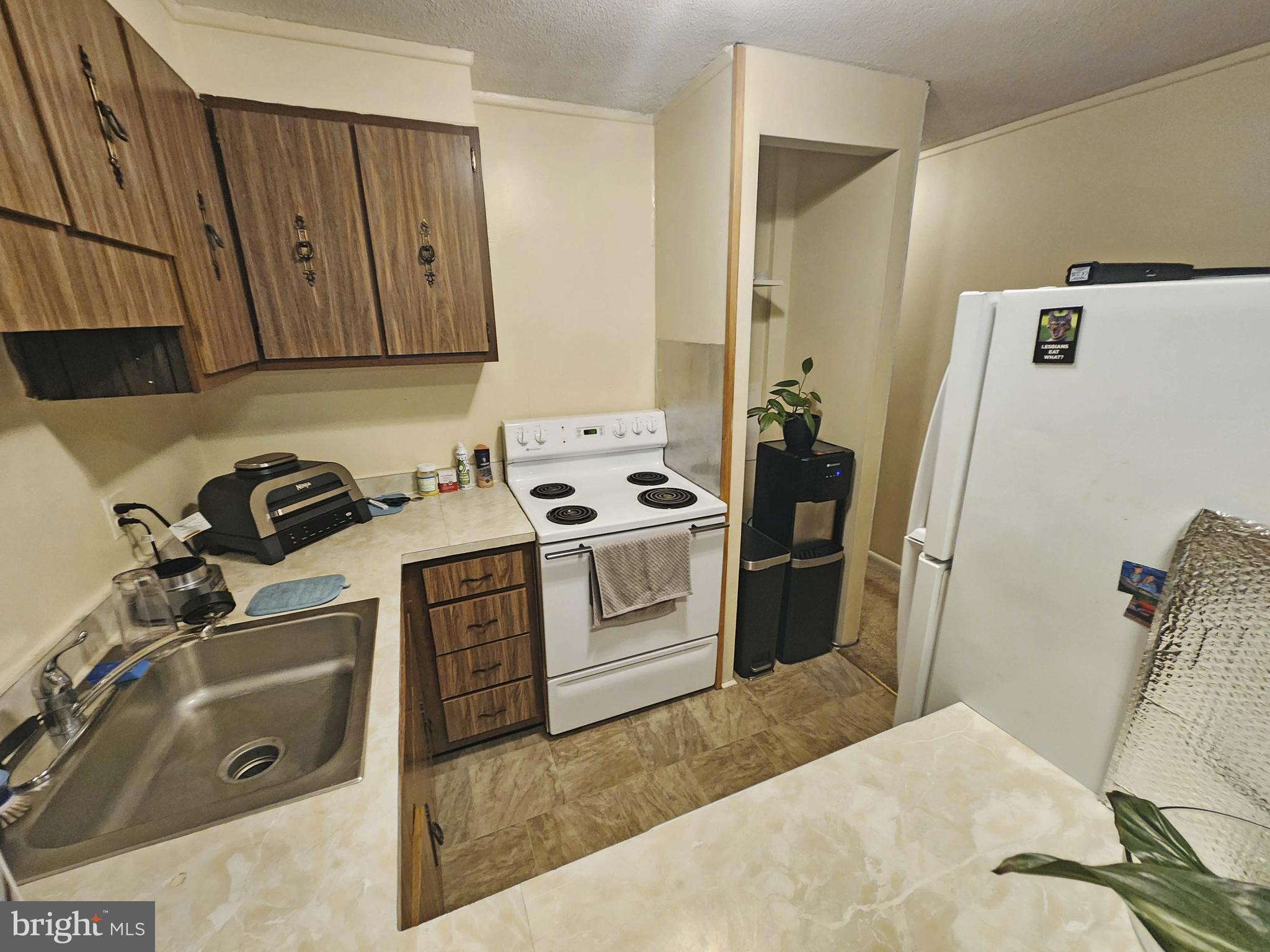 14001 Coastal Highway, Unit 322 Ocean City, MD 21842 - Photo 8 of 10 a view of a kitchen with sink dryer and washer