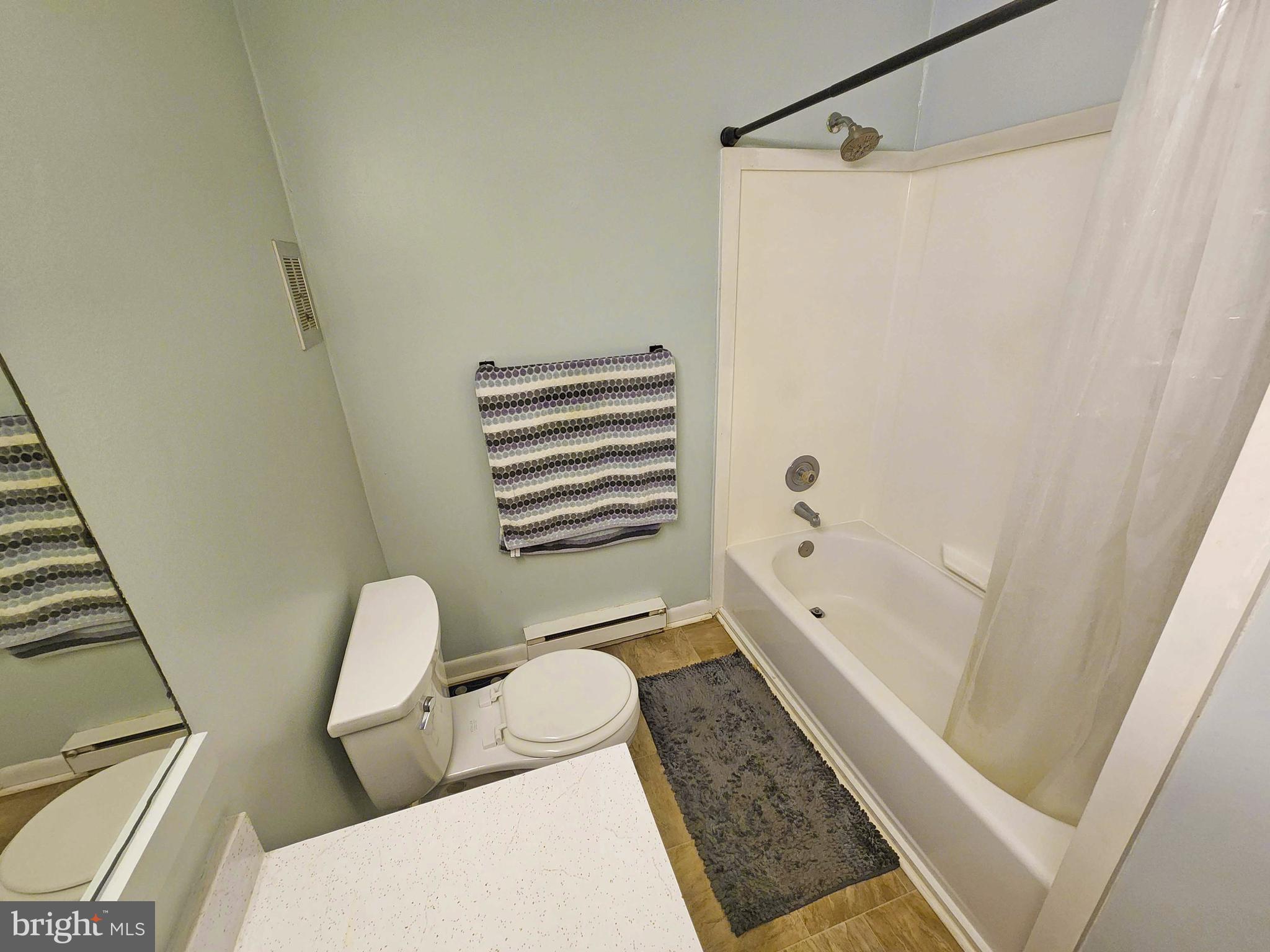 14001 Coastal Highway, Unit 322 Ocean City, MD 21842 - Photo 9 of 10 a bathroom with a tub and a shower
