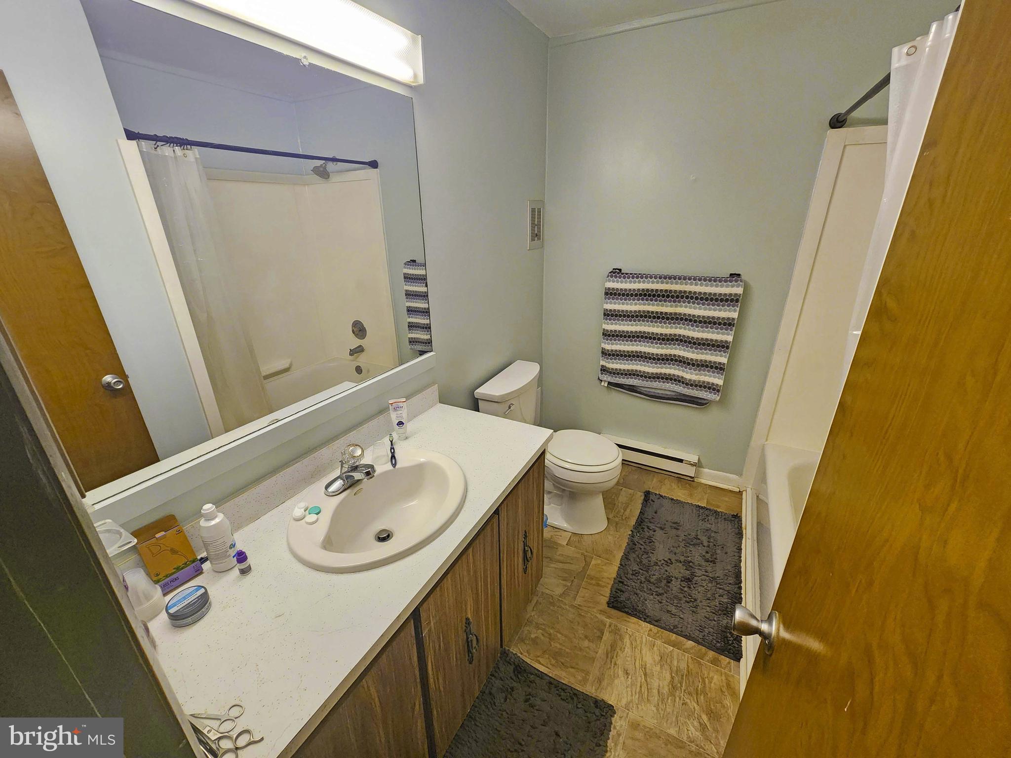 14001 Coastal Highway, Unit 322 Ocean City, MD 21842 - Photo 10 of 10 a bathroom with a sink a toilet and a mirror