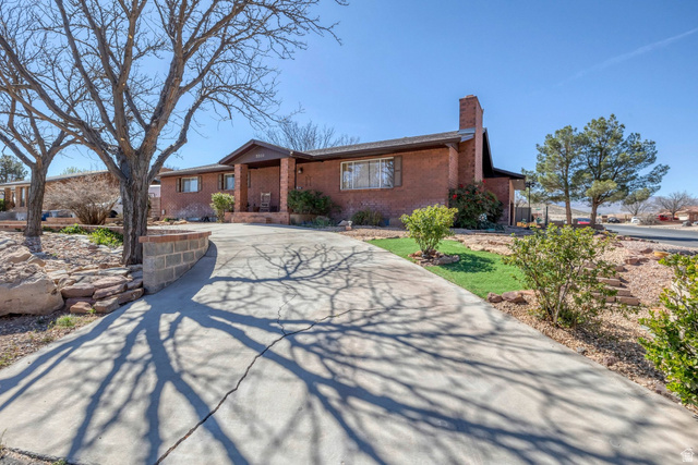 3334 Ute Road St. George, UT 84790 - Photo 38 of 40 Ranch-style house with a chimney, brick siding, and concrete driveway