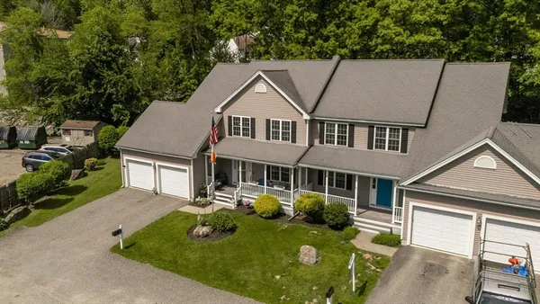 a aerial view of a house with yard porch and furniture