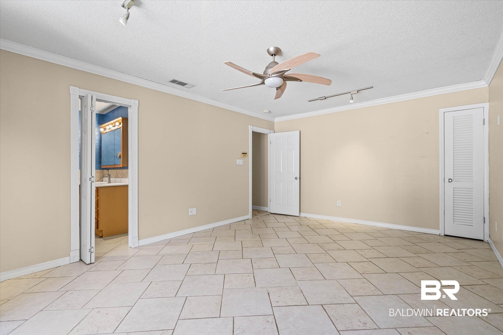 3724 Claridge Road South Mobile, AL 36608 - Photo 20 of 42 Unfurnished bedroom with rail lighting, crown molding, ceiling fan, a textured ceiling, and ensuite bath