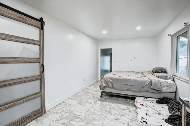 a bedroom with a bed and a window