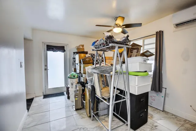 a view of a dining room with furniture and chandelier fan