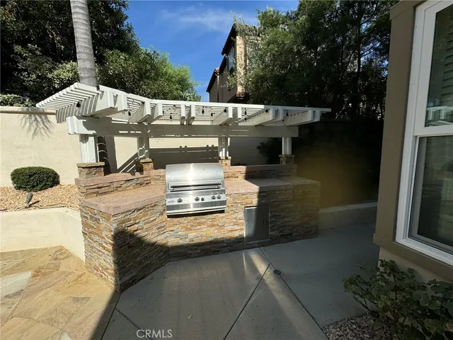 a kitchen with stainless steel appliances granite countertop a sink a stove and a refrigerator