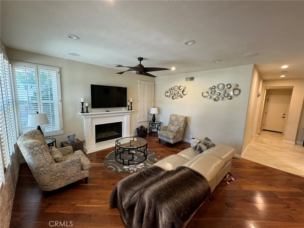 6 Lakeridge Rancho Santa Margarita, CA 92679 - Photo 17 of 75 a living room with furniture a fireplace and a flat screen tv