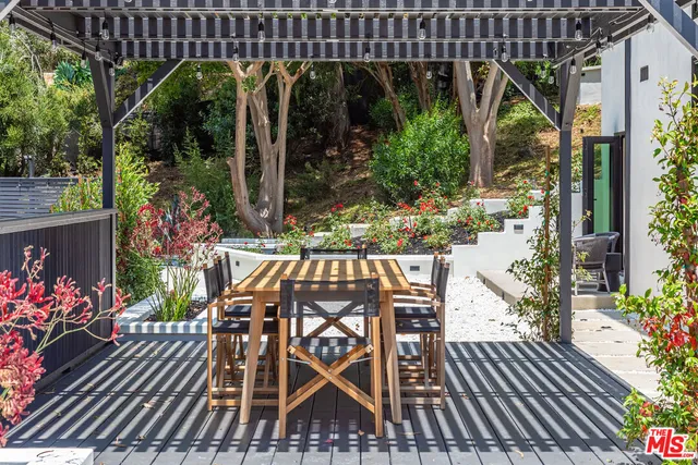 a view of a chairs and table on the roof deck