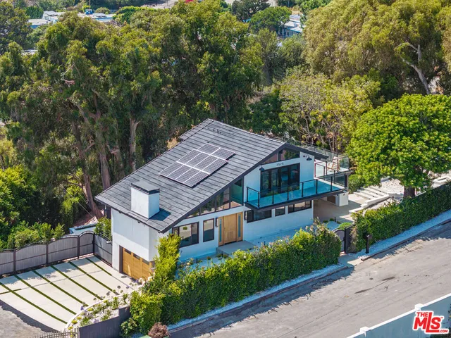 an aerial view of a house with a garden