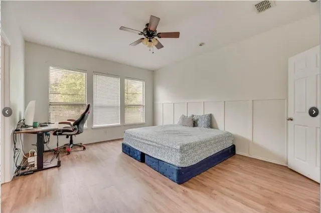 a living room with a bed furniture and a large window