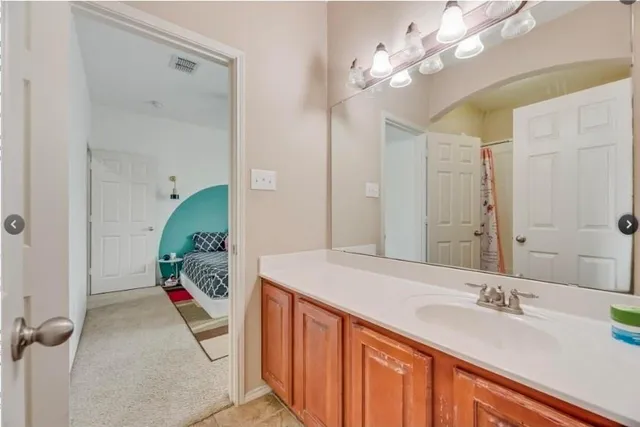 a bathroom with a sink vanity tub and shower
