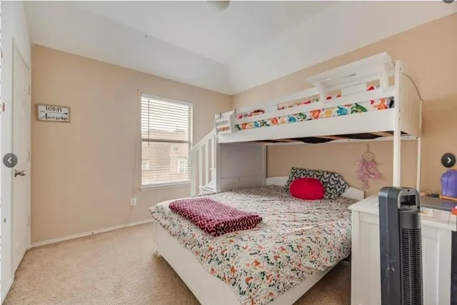 a bedroom with a bed and window