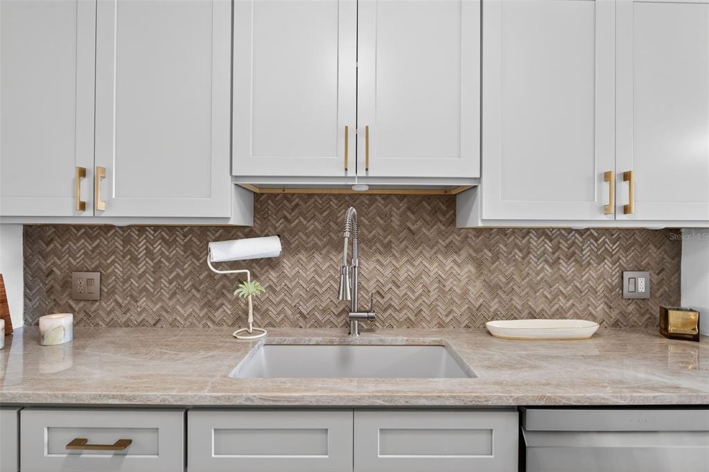 427 Boca Ciega Point Boulevard North St. Petersburg, FL 33708 - Photo 18 of 69 a kitchen with a sink and cabinets