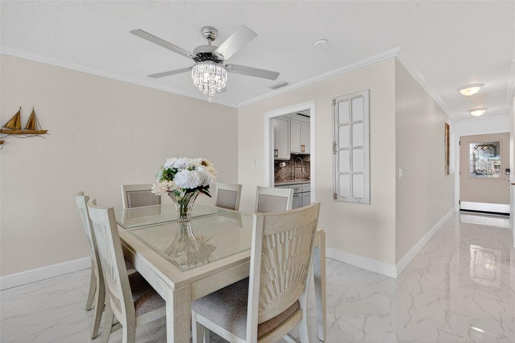 427 Boca Ciega Point Boulevard North St. Petersburg, FL 33708 - Photo 21 of 69 a view of a dining room with furniture and chandelier