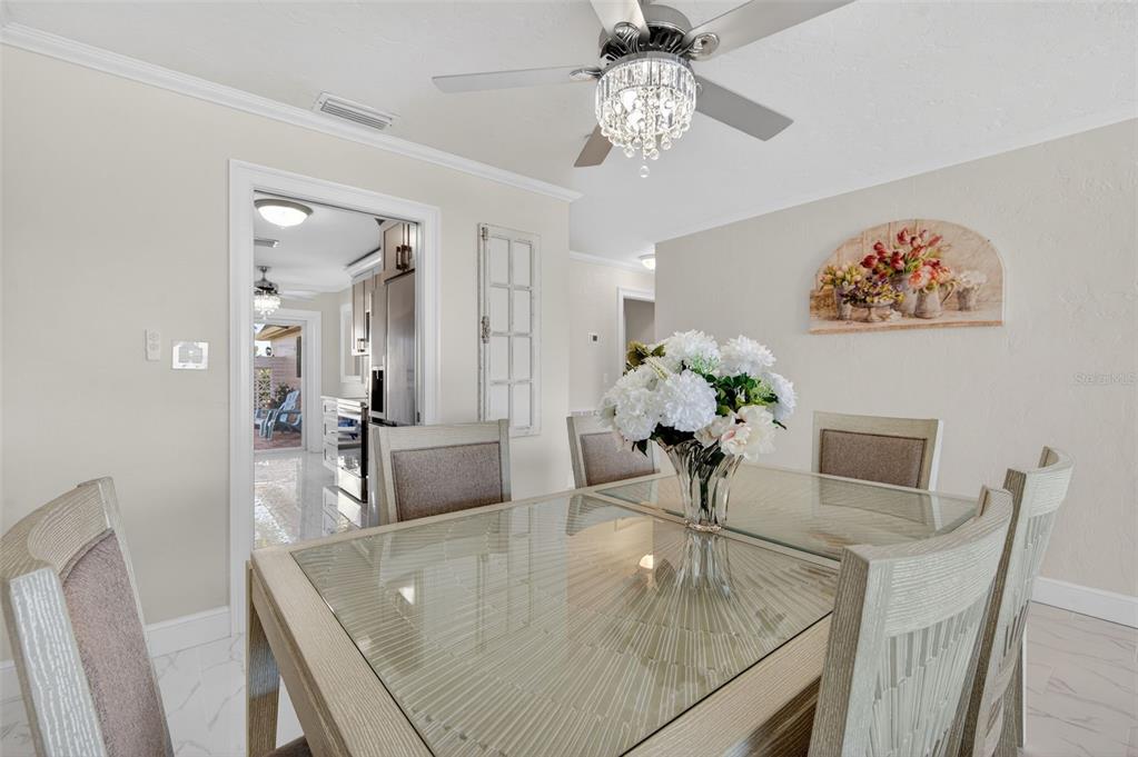 427 Boca Ciega Point Boulevard North St. Petersburg, FL 33708 - Photo 22 of 69 a dining room with furniture and a chandelier