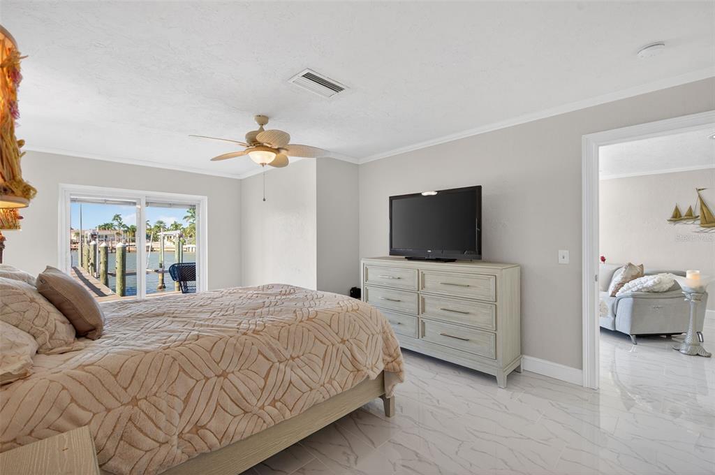 427 Boca Ciega Point Boulevard North St. Petersburg, FL 33708 - Photo 28 of 69 a bedroom with a bed and flat screen tv