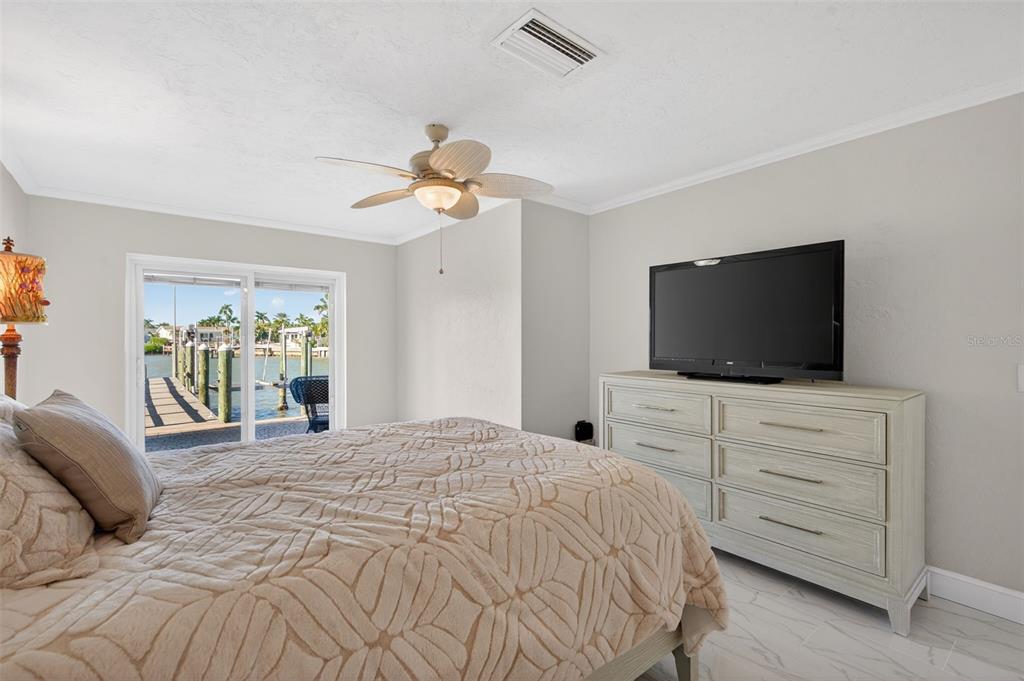 427 Boca Ciega Point Boulevard North St. Petersburg, FL 33708 - Photo 29 of 69 a bedroom with a bed and a flat screen tv