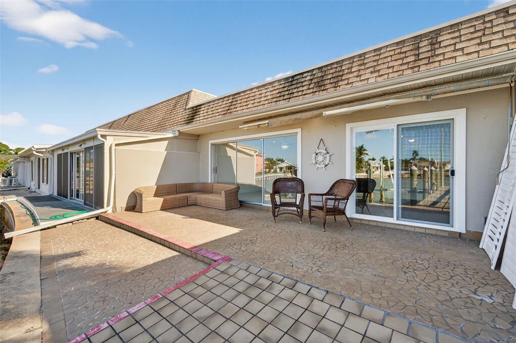 427 Boca Ciega Point Boulevard North St. Petersburg, FL 33708 - Photo 43 of 69 a view of a house with backyard porch and sitting area