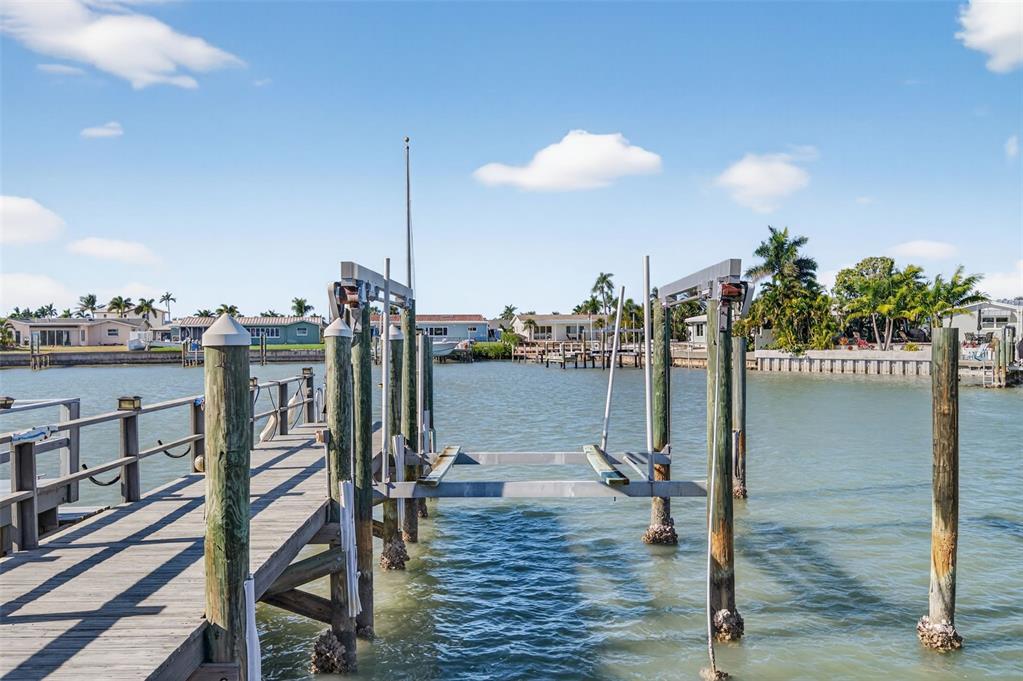 427 Boca Ciega Point Boulevard North St. Petersburg, FL 33708 - Photo 47 of 69 a view of a balcony with floor to ceiling windows and wooden floor