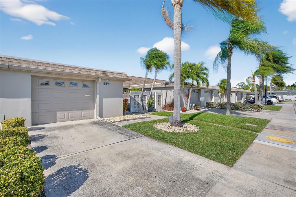 427 Boca Ciega Point Boulevard North St. Petersburg, FL 33708 - Photo 66 of 69 a front view of a house with garden and trees
