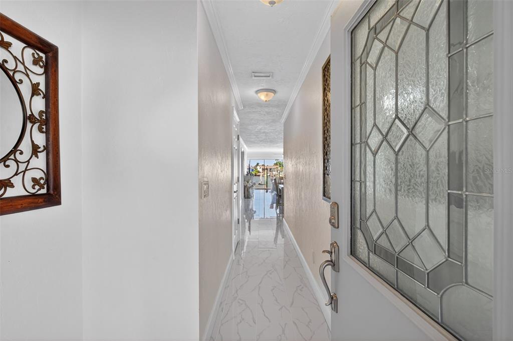 427 Boca Ciega Point Boulevard North St. Petersburg, FL 33708 - Photo 8 of 69 a view of a hallway with wooden floor and glass door