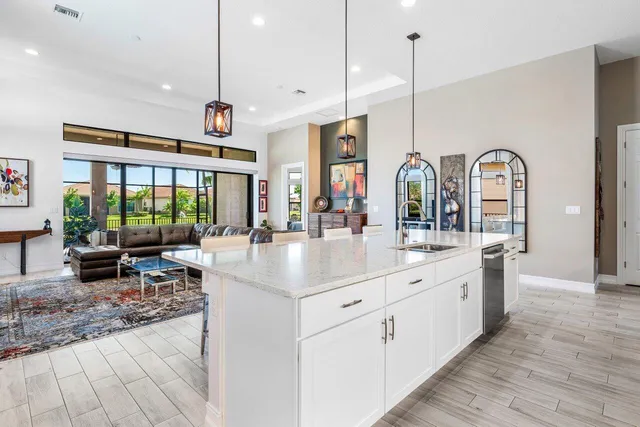 a kitchen with sink and view of living room