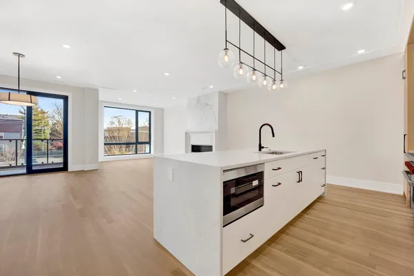 a view of kitchen with sink and wooden floor