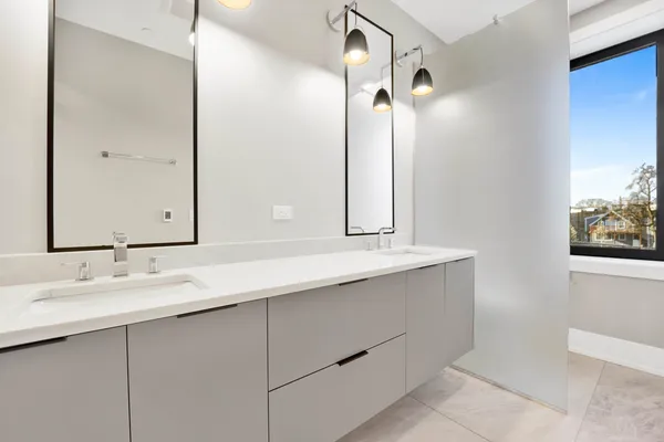 a bathroom with a double vanity sink mirror and double