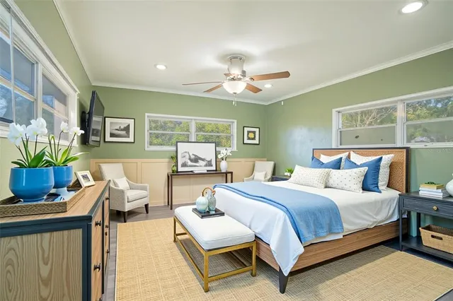 a bedroom with a bed and ceiling fan