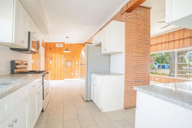 a kitchen with a refrigerator a stove top oven a sink and dishwasher