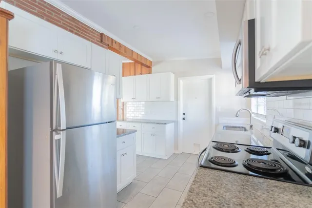 a kitchen with a refrigerator and a sink