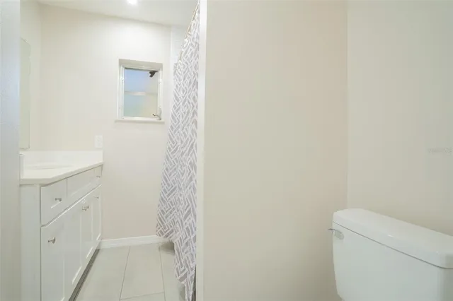 a bathroom with a toilet a sink and vanity