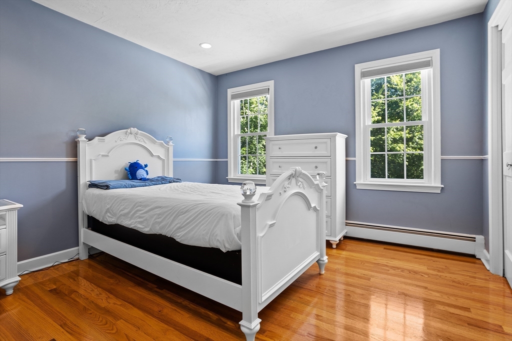 4 Fox Lane Westborough, MA 01581 - Photo 26 of 37 a bed sitting in a bedroom next to a window